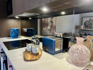 a kitchen with a counter with a vase on it at No 50 - Beautiful apartment in Liverpool Sleeps 4 in Liverpool +8 photos