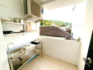 a small kitchen with a sink and a window at Patong Canal Villa 204 in Patong Beach