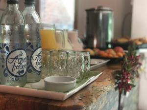 a counter with several glass jars and bottles of orange juice at Hotel Francia in San Rafael