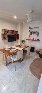 a living room with a wooden table and chairs at Casa Rave 17 in Córdoba