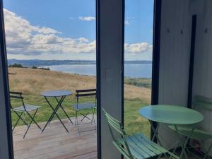 a view of a patio with a table and chairs at Aorangi Peak Cabins 8 by Tiny Away in Rotorua