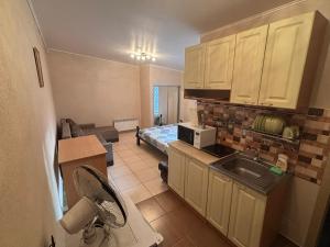 Una cocina con fregadero y una habitación con cama. en "Sunny Island" уютные дома с террасой, рядом море Одесса, en Odessa 10 fotos más