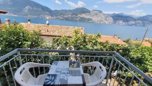 a table and chairs on a balcony with a view at Point of View in Brenzone sul Garda