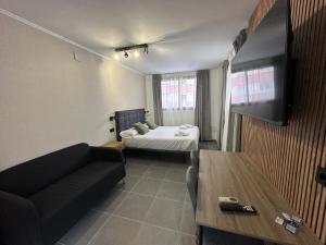 a living room with a couch and a bed at AH Rentals Suites in Vinarós +66 photos