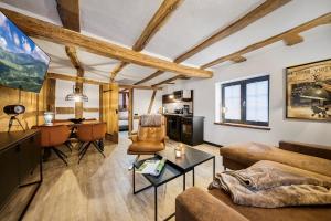 a living room with a couch and a table at Vollmer's Hof in Bad Berleburg