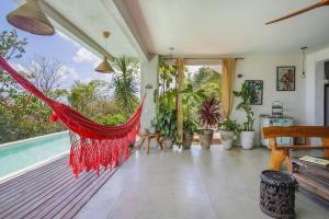 a hammock in the living room of a house at Casa Dahomey in Pipa