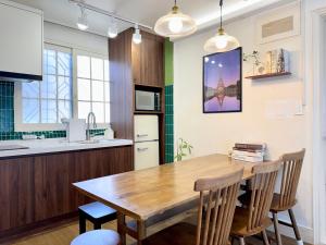 a kitchen with a wooden table and chairs at Pachira House in Seoul