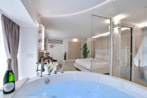 a bathroom with a tub and a living room at Domus De Cinti in Tivoli +12 photos