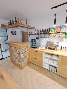 a kitchen with a counter with bottles and shelves at Pokoje u Daniela in Miedzygorze