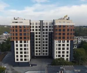two tall white buildings in a city at Gold in Chişinău