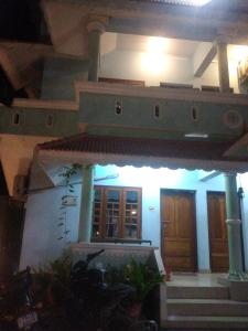 a house with a staircase in front of it at Couple flats in Varkala