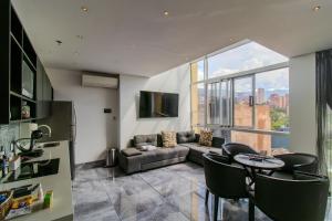a living room with a couch and a table at Haven A Design Hotel in Medellín