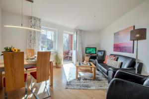 a living room with a couch and a table at "Landhaus Voss" Typ 3 Nr9 in Staberdorf