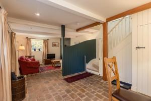 a living room with a sliding door in a house at The Coach House at Noelle's Cottages in Pickering