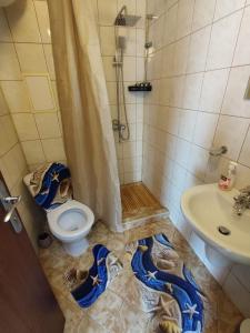 a bathroom with a shower and a toilet and a sink at Апартамент - студио в кв Сарафово с морски изглед in Burgas City
