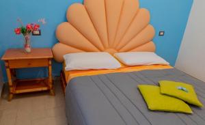 a bedroom with a large bed with a large headboard at MARE NOSTRUM - Beachfront House with Sea View - 2 Bedrooms - Sant'Angelo Ischia in Sant'Angelo D'Ischia
