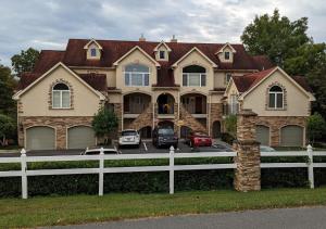una grande casa con macchine parcheggiate di fronte di Relaxing Condo on the River - NEW Air Hockey Table a Pigeon Forge