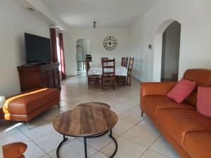 a living room with a couch and a table at Villa L'Audaline in Roquebrune-sur-Argens