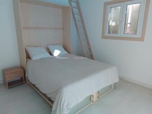 a bedroom with a bed with a ladder next to a window at Villa L'Audaline in Roquebrune-sur-Argens +13 photos