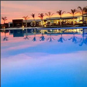 a large building with palm trees in front of it at The Blyde in Pretoria