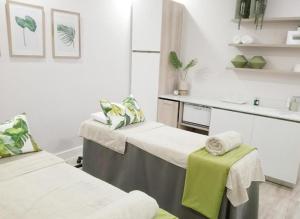 a hospital room with two beds and a sink at The Blyde in Pretoria