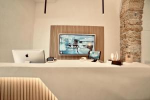 an office with a desk with a computer and a laptop at Palermo Inn Boutique Arte in Palermo