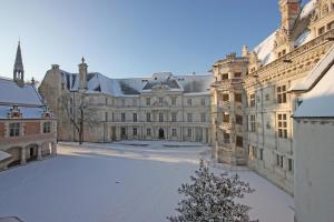 a large building with snow on the ground at Gîte la Basilique in Blois