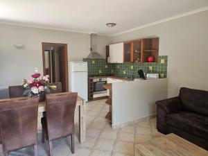 a kitchen and living room with a table and chairs at Rez de villa in Borgo