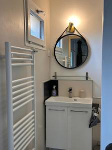 a bathroom with a sink and a mirror at Le Bulloire in Montlouis-sur-Loire +28 photos