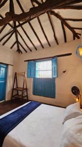 a bedroom with a large bed and a window at Casa Raisol Barichara in Barichara