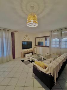 a large living room with a couch and a television at Bèl Péyi - Bas de Villa T4 Proche de la Plage in Bouillante +44 photos