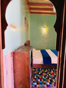 Postel nebo postele na pokoji v ubytování Kasbah Ait Bouguemez