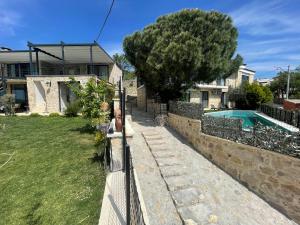 a house with a fence and a swimming pool at Assosa Country House in Ayvacık