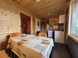 a dining room with a table with a box on it at Kwatery U Marka in Gowidlino