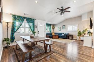 a living room with a table and a couch at ¤ Old Folsom La Boheme Artist Retreat + Jacuzzi ¤ in Folsom