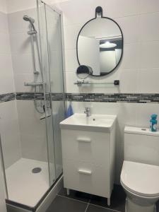 a bathroom with a toilet and a sink and a mirror at Whoua Charmant appart Mérignac in Mérignac