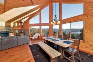 a dining room with a table and a couch at High-Top Lakeview Chateau Relaxing Modern Fawnskin Retreat in Fawnskin