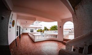 an empty hallway of a building with a balcony at Las Palmas Hotel in Corozal
