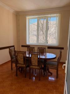 a dining room with a table and chairs and a window at Lenko in Goris