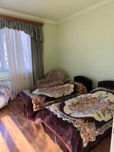 a room with three beds sitting on the floor at Lenko in Goris