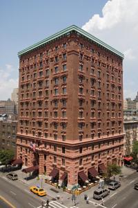 a large red brick building on a city street at Hotel Lucerne in New York