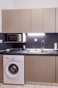 a kitchen with a washing machine and a sink at ANGO City Center in Stavros +41 photos