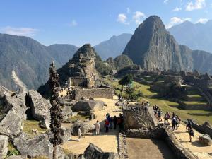a group of people standing at the ruins of a mountain at La Maison Samaï in Urubamba