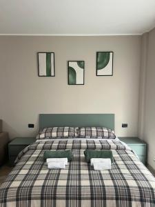 a bedroom with a large bed with two pillows at Turin Bicerin Green in Turin