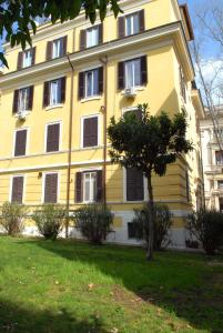 a yellow building with a tree in front of it at Divine Bed & Breakfast in Rome