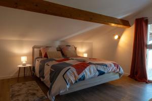 a bedroom with a large bed with two lamps at Le Havre du Lac in Brignemont +49 photos