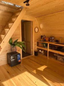 a room in a log cabin with a tv in it at VILLA ROKITI near Kutaisi in Rokit'i