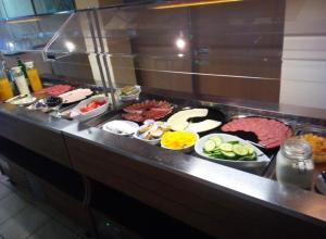 a buffet line with different types of meats and vegetables at Hotel Tannenhof in Lauterbach