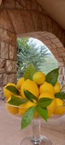 a bowl of lemons on a table with a window at Villa Verde in Cefalù