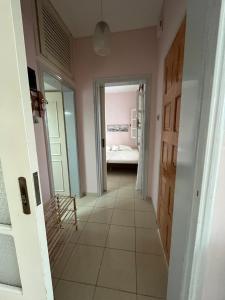 a hallway with a door and a room with a bed at ANASTASIA HOUSE in Sozopoli
